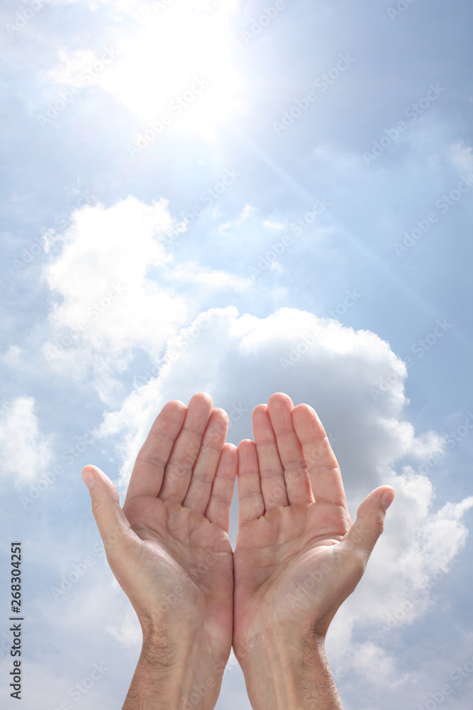 open man's hands rising to the sky in a pray gesture with copy space for your text open man's hands rising to the sky in a pray gesture with copy space for your text