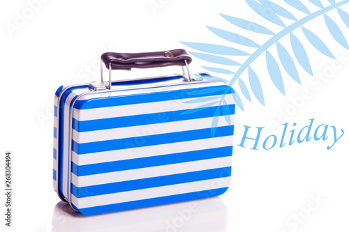 Holiday - blue suitcase ready to travel on white background