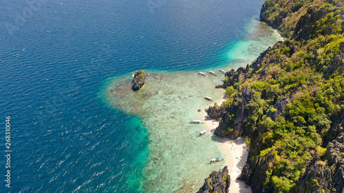 Tropical island with white beach and coral reef.Tourist boats near the island. El Nido Palawan National Park Philippines. © Tatiana Nurieva
