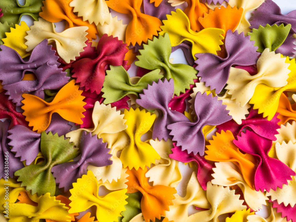 Italian colored dried farfalle pasta, a background pattern