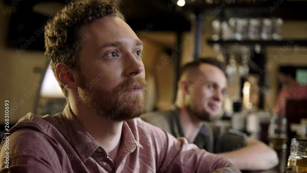 Cheerful friends drinking draft beer in a pub Cheerful friends drinking draft beer in a pub