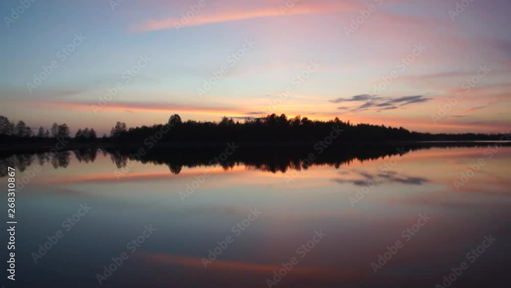 Beautiful sunset on a forest lake with a contrasting sky and reflection in the water. Beautiful sunset on a forest lake with a contrasting sky and reflection in the water.