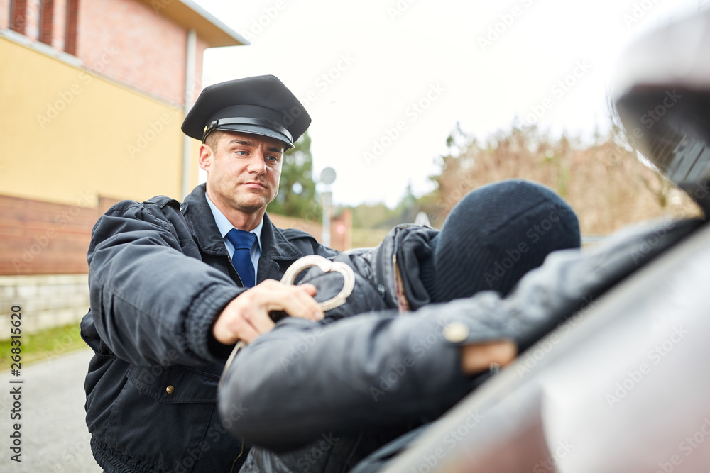 Fototapeta premium Polizist bei Festnahme von Einbrecher