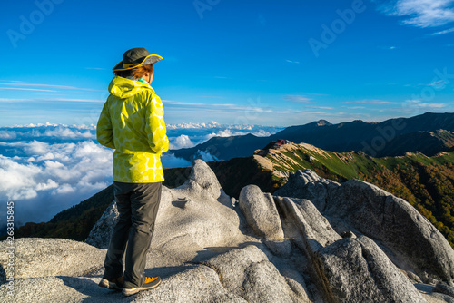 Epic adventure of hiker do trekking activity in mountain of Northern Japan Alps, Nagano, Japan, with panoramic nature mountain range landscape. Motivation leisure sport and discovery travel concept. photo