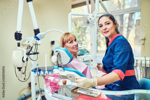  Smiling and satisfied patient in a dental office
