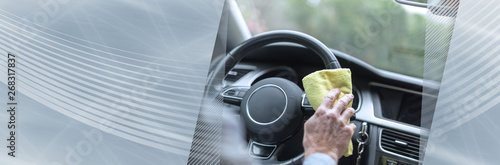 Man cleaning a car steering wheel. panoramic banner © thodonal
