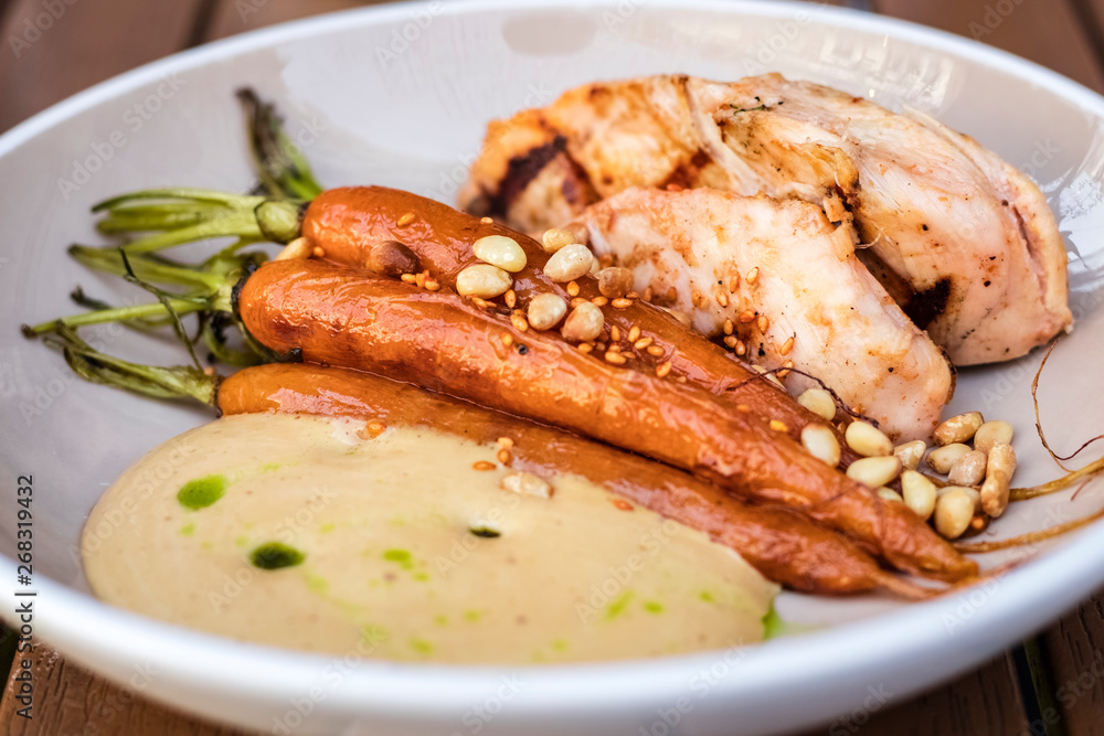 delicious dish of fried chicken and braised carrots with pine nuts. Cream sauce
