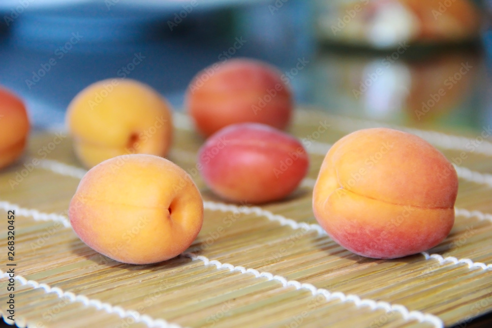 orange fresh summer apricots on a wooden carpet background orange fresh summer apricots on a wooden carpet background