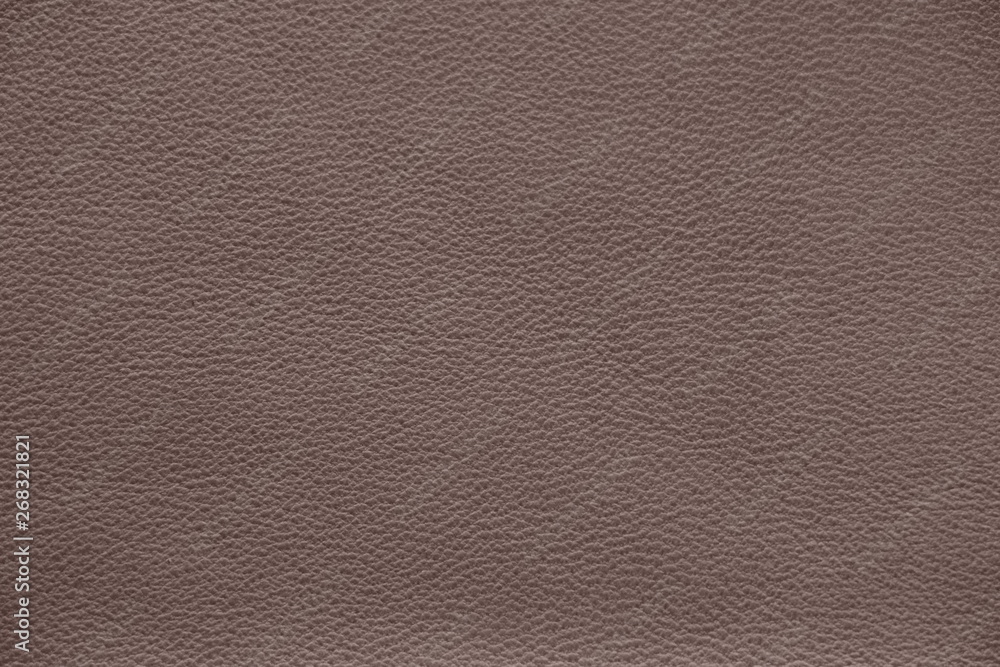 Fototapeta premium The texture of genuine leather. Impeccable and stylish background. Beautiful stylish background. Natural skin texture close up. Brown background. The structure of the leather material brown shades.