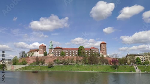 4k timelapse of clouds flying over walls and towers of Wawel hill in Krakow, Poland on a fine windy day in Spring photo