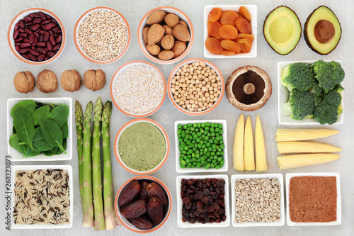 Obraz na plátně High protein source plant health food with fresh vegetables, legumes, dried fruits, nuts, supplement powders, grains and seeds on rustic white wood, high in dietary fibre, antioxidants and vitamins
