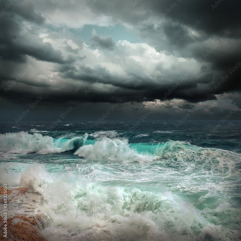 Stormy sea view  near coastline at evening time. Waves, splashed