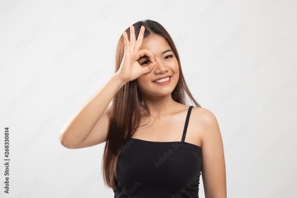 Beautiful young Asian woman show OK sign over her eye. Beautiful young Asian woman show OK sign over her eye.
