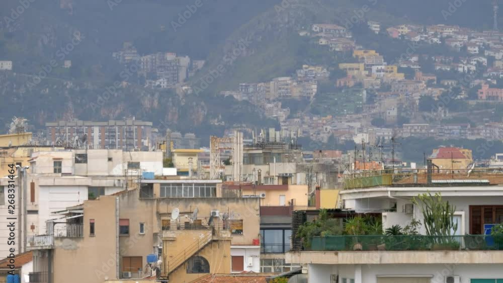 A Palermo landscape with houses, seagulls and hills in the background A Palermo landscape with houses, seagulls and hills in the background