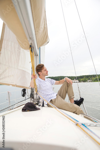 Handsome young man on yacht. © Object Studio