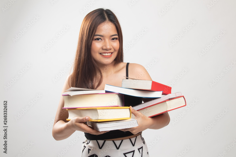 Young Asian woman studying with may books. Young Asian woman studying with may books.