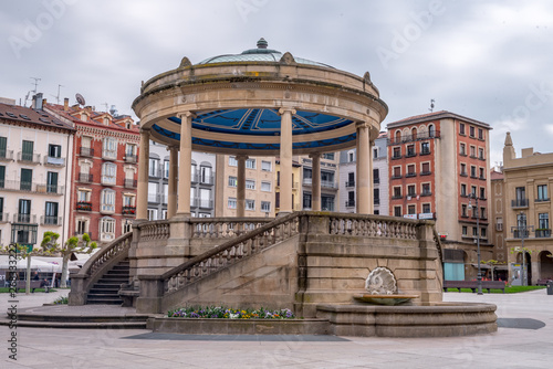 Pamplona,Navarra, Spain :-02 May 2019: Plaza del Castillo of Pamplona side image in which you can see the buildings that form it and the central kiosk. without just people photo