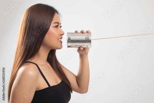 Young Asian woman with tin can phone.