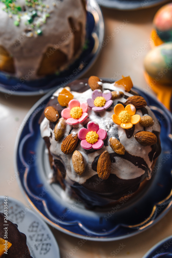 Easter cake and painted eggs on wooden table. Festive composition in rustic style, Springtime. Flat lay, top view background. vertical photo Easter cake and painted eggs on wooden table. Festive composition in rustic style, Springtime. Flat lay, top view background. vertical photo