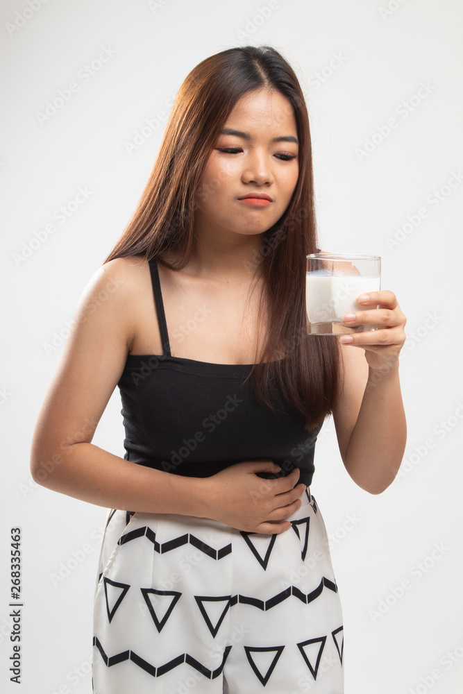 Asian woman drinking a glass of milk got stomachache. Asian woman drinking a glass of milk got stomachache.