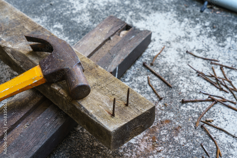 Hammer, rusty nail and wood for carpenter's job Hammer, rusty nail and wood for carpenter's job