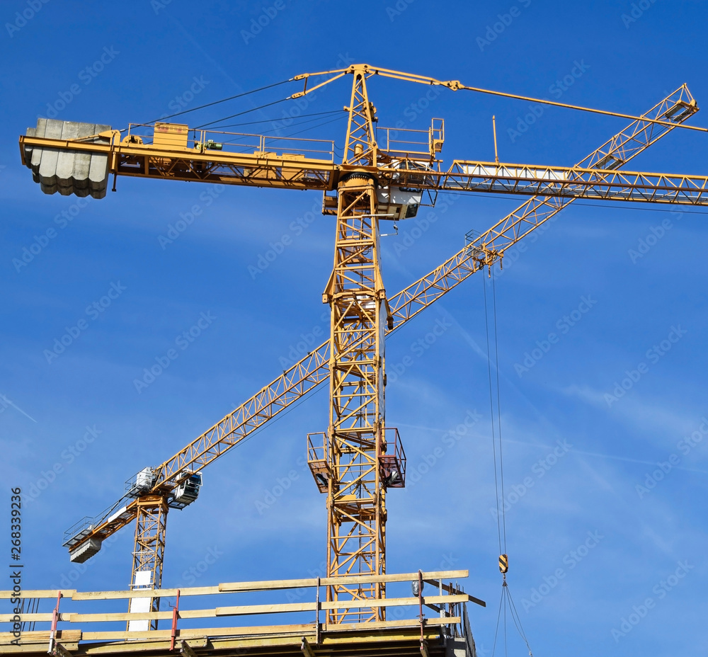 Tower cranes at the construction site Tower cranes at the construction site
