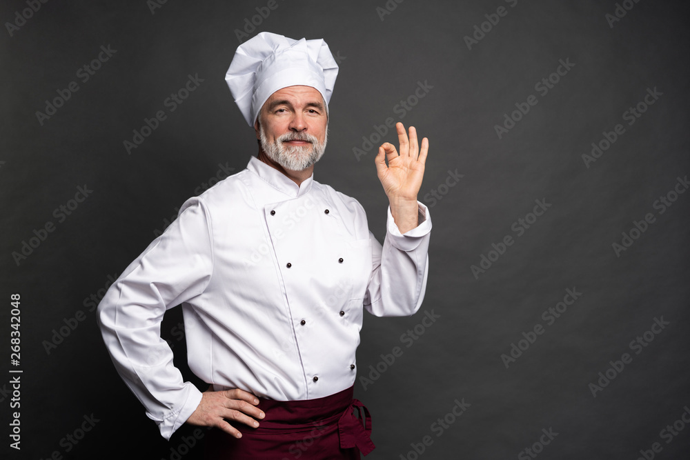 Chef making tasty delicious gesture by kissing fingers. Confident bearded male chef in white uniform with perfect sign. Chef making tasty delicious gesture by kissing fingers. Confident bearded male chef in white uniform with perfect sign.