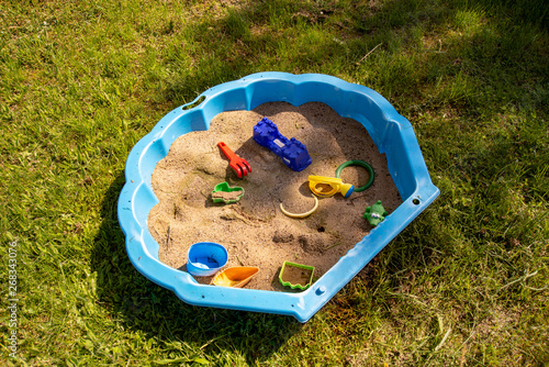 High angle view of sandbox with toys spread on the sand