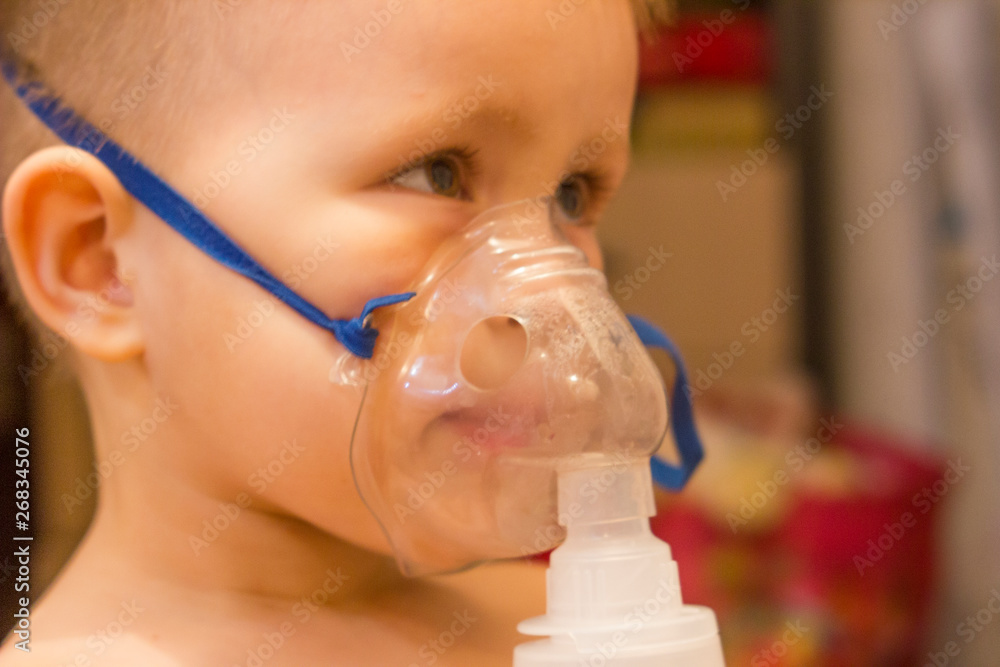 Blurred photo. Child asthma inhaler inhalation nebulizer steam sick cough concept. Medical procedures. Inhaler. Respiratory medicine. Bronchitis, asthmatic health equipment. Concept of home treatment