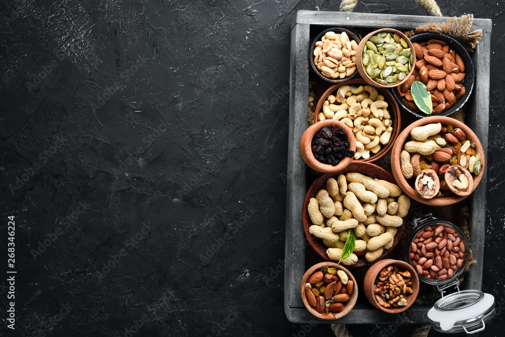 Set nuts and dried fruit in a wooden box. Top view. Free space for your text. Set nuts and dried fruit in a wooden box. Top view. Free space for your text.
