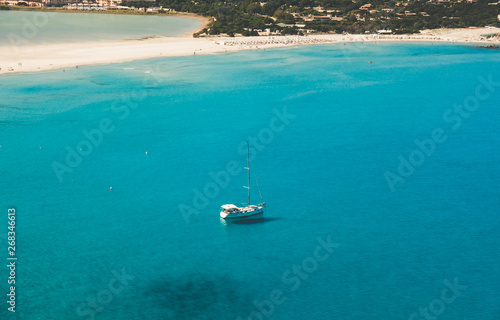 Beautiful White Beach with Boat in the Turquoise Sea of Sardinia