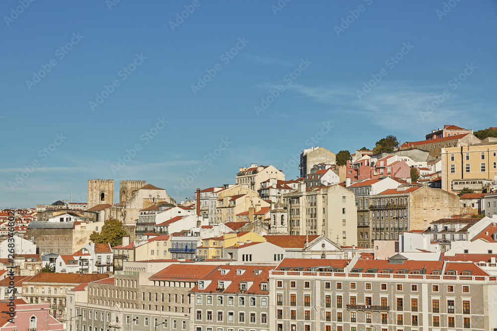 Fototapeta premium View of traditional architecture and houses on Sao Jorge hill in Lisbon, Portugal.