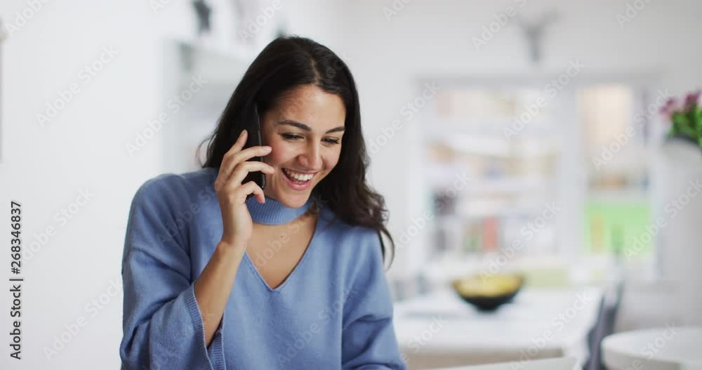 4K Smiling professional woman making a friendly phone call, could be talking to a business contact or a friend. Slow motion. 4K Smiling professional woman making a friendly phone call, could be talking to a business contact or a friend. Slow motion.
