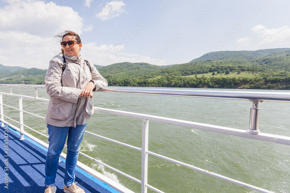 Happy tourist woman enjoy view of Danube river at cruise ship