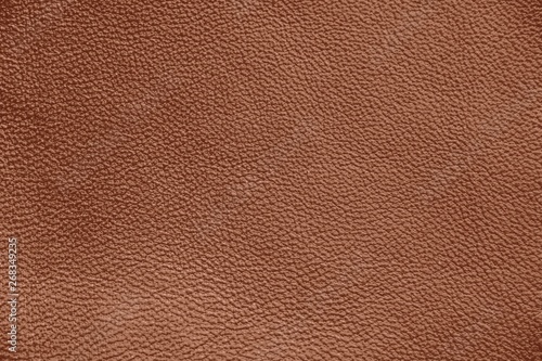 The texture of genuine leather. Brown background. The structure of the leather material brown shades.