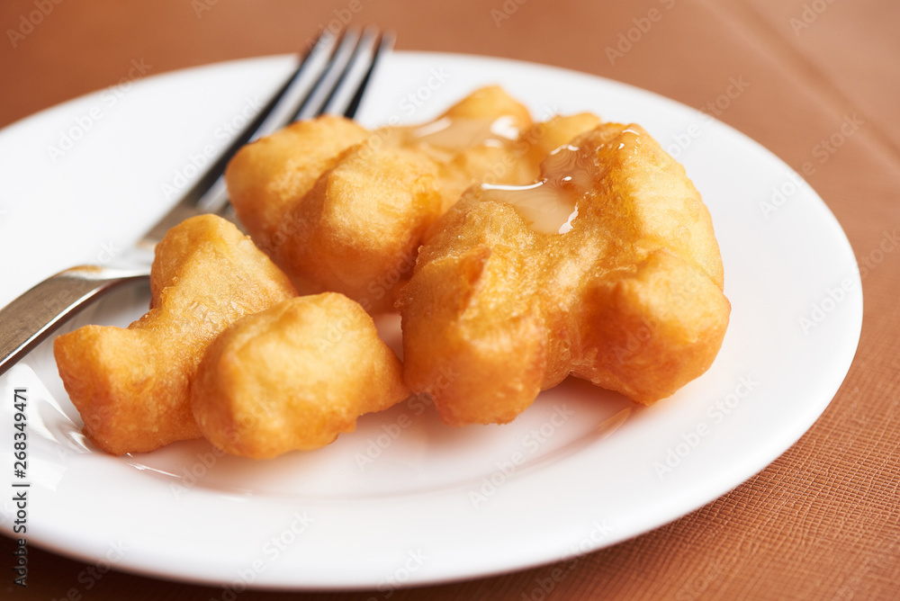 A plate of delicious deep fried dough stick A plate of delicious deep fried dough stick