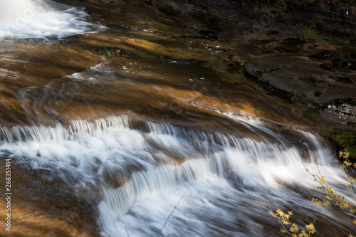 A natural waterfall outdoors in the woods