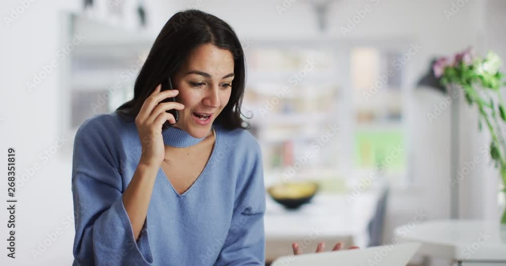 4K Beautiful Spanish woman working on laptop & having phone chat with a friend. Slow motion. 4K Beautiful Spanish woman working on laptop & having phone chat with a friend. Slow motion.