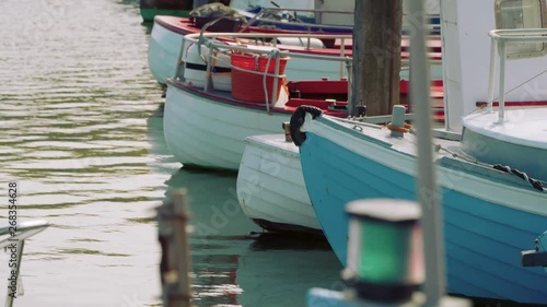Close up fishing boats in Dasnish harbor, water and reflection.