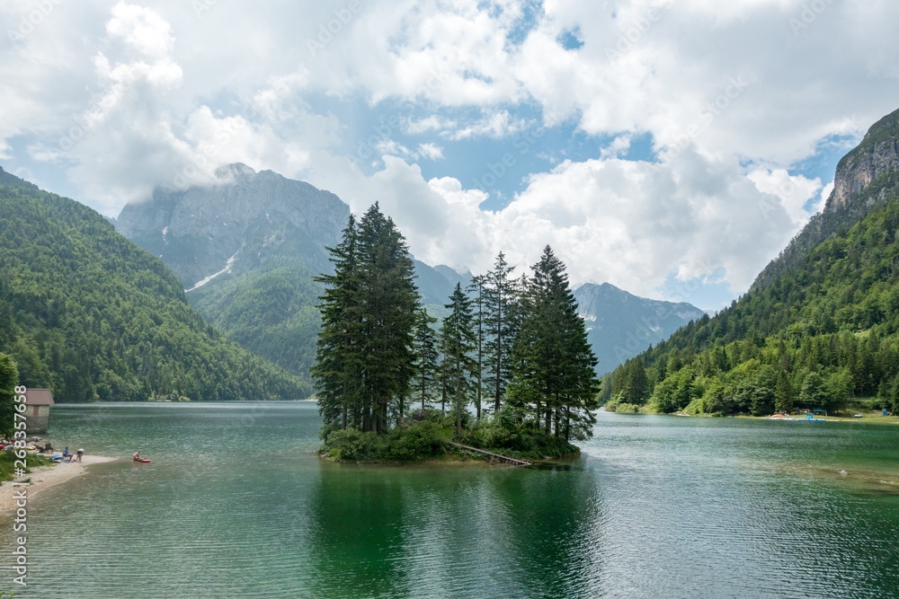 Island lake with forests in the river. Julian Alps in Slovenia, Italy, Austria Border