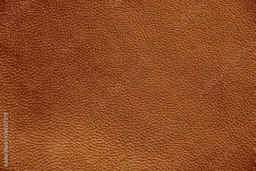 The texture of genuine leather. Impeccable and stylish background. Beautiful stylish background. Natural skin texture close up. Brown background. The structure of the leather material brown shades.