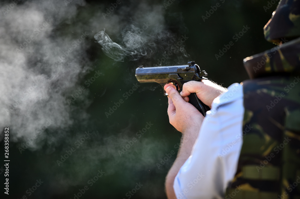 Outdoor target shooting with a 9mm pistol in a shooting range Outdoor target shooting with a 9mm pistol in a shooting range
