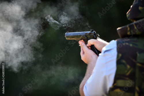 Outdoor target shooting with a 9mm pistol in a shooting range