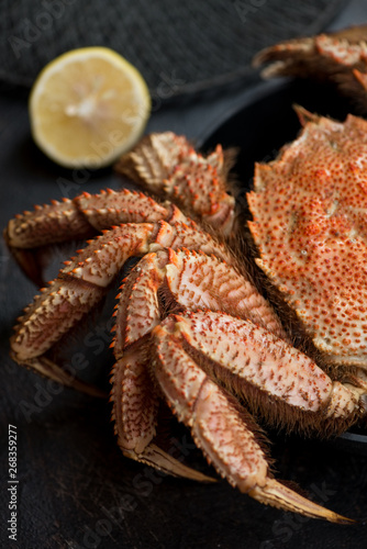 Close-up of boiled horsehair crab with lemon, vertical shot, selective focus