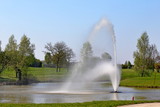 Water fountain on pond, on meadow
