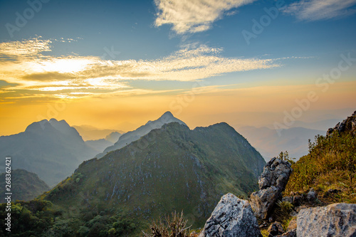 Golden Cloud and sunset sky at wildlife sanctuary name Doi Luang Chiang Dao, Thailand with Shadow of mountain layer and sun ray.