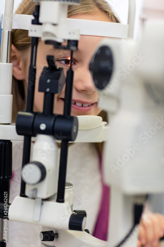 Close up girl on ophthalmoscope