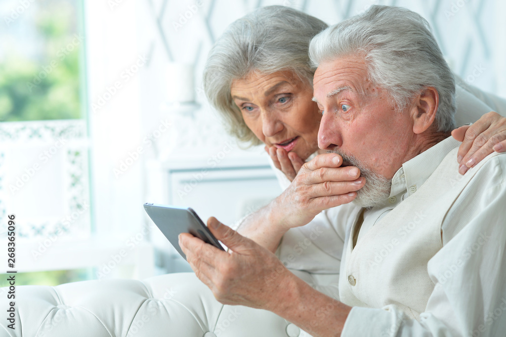 Portrait of happy senior couple using tablet Portrait of happy senior couple using tablet