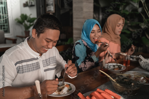 friends gathering  enjoy the iftar meal in the backyard house