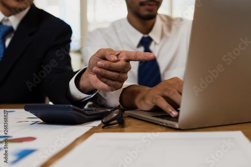 Business participate and consulting of teamwork, Business people planing and brainstorming to financial project  with finance graph and laptop on table in office